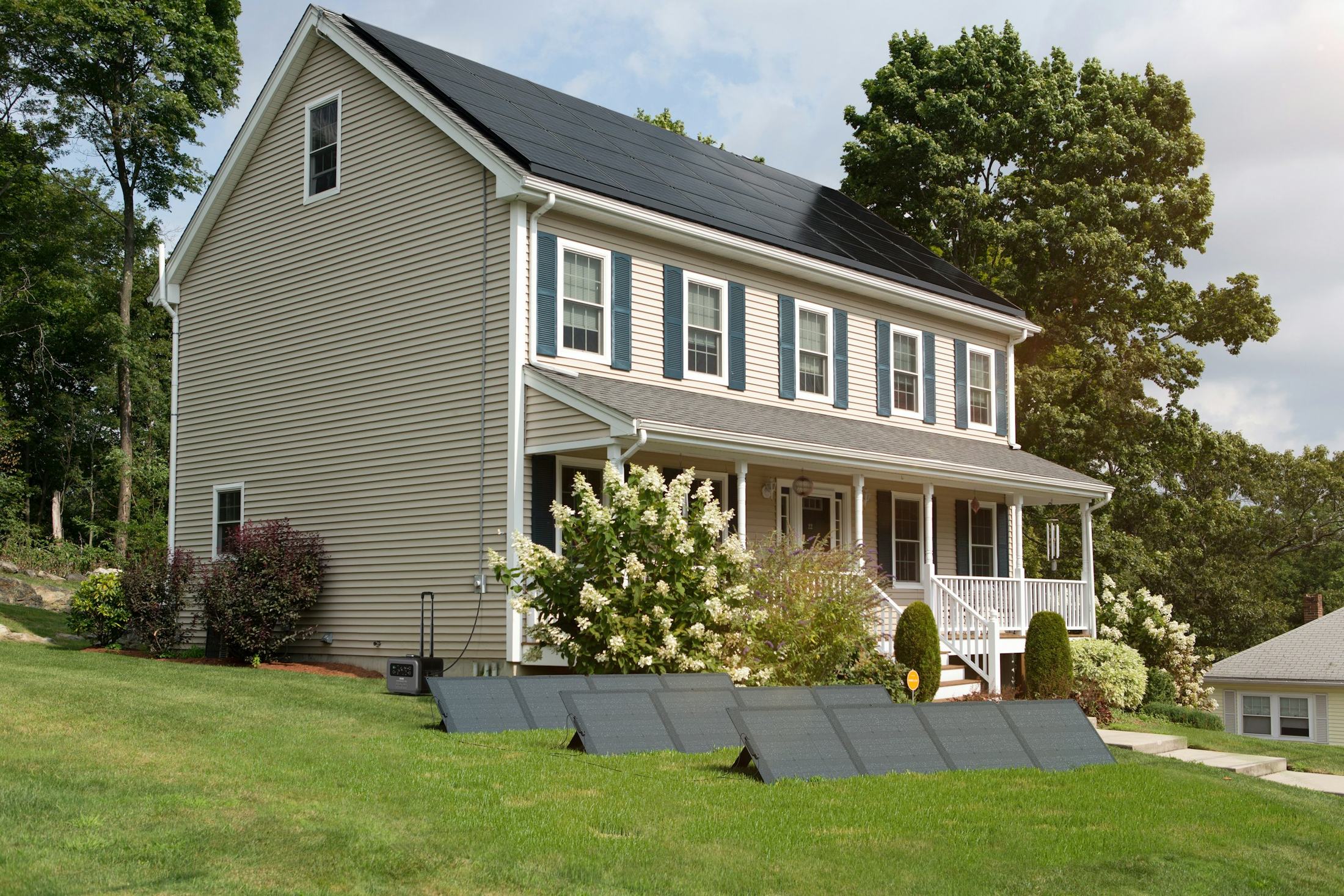 Two-storey family home with black solar panels on the roof