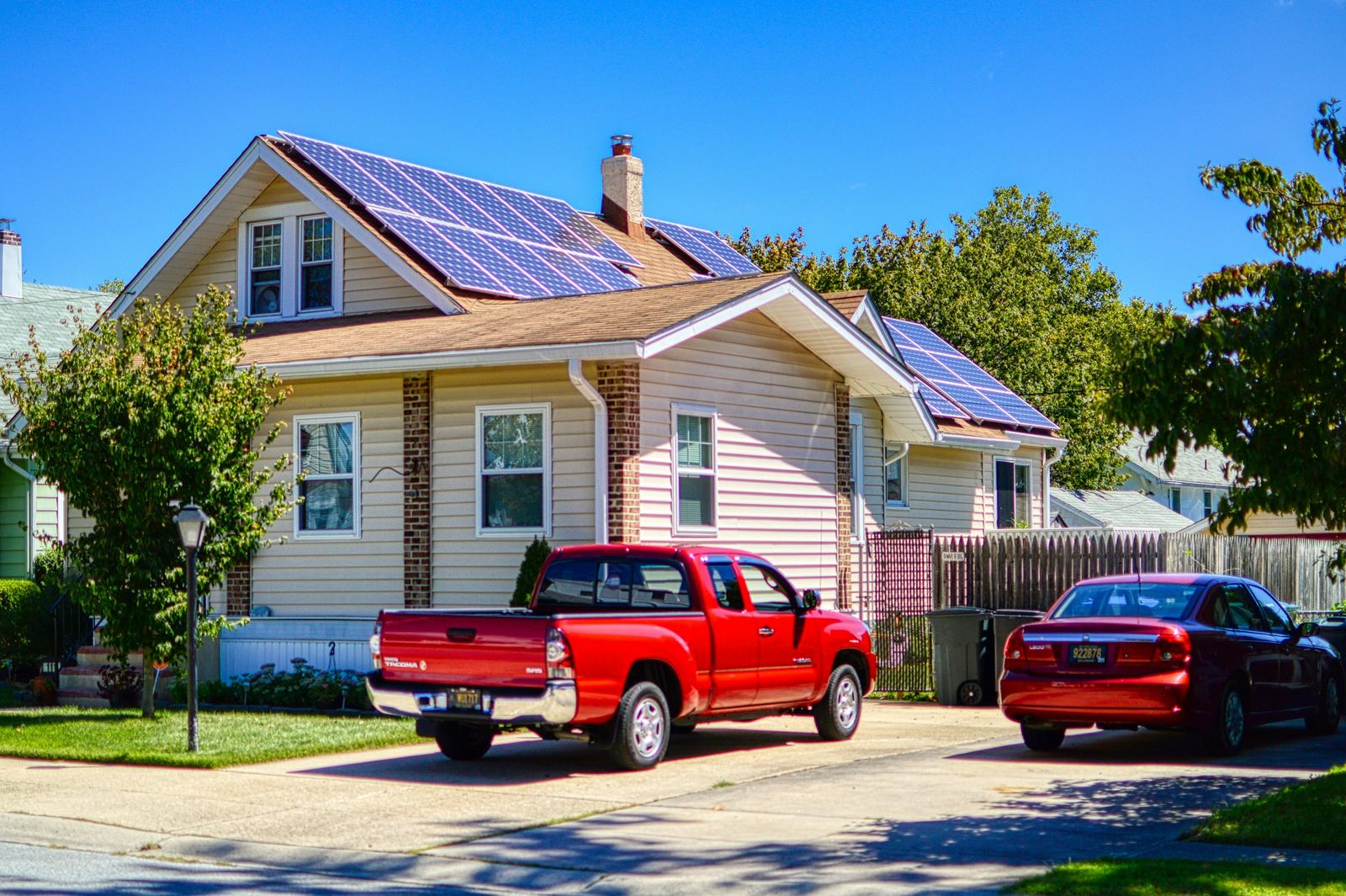 Family home with solar panels on a sunny street